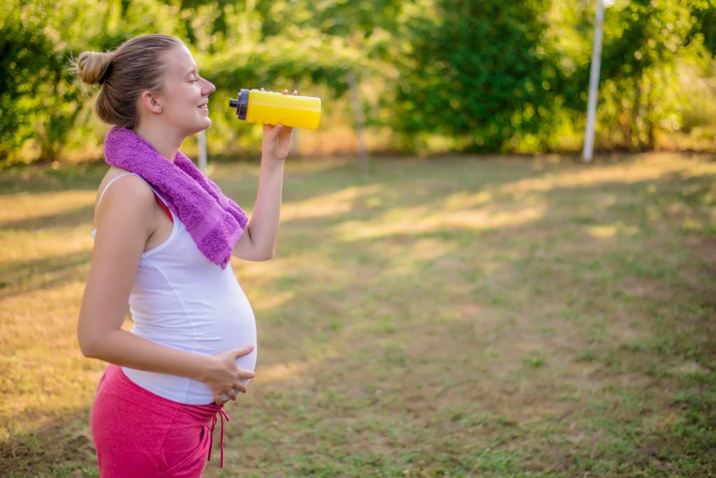 Pregnant woman exercising outside