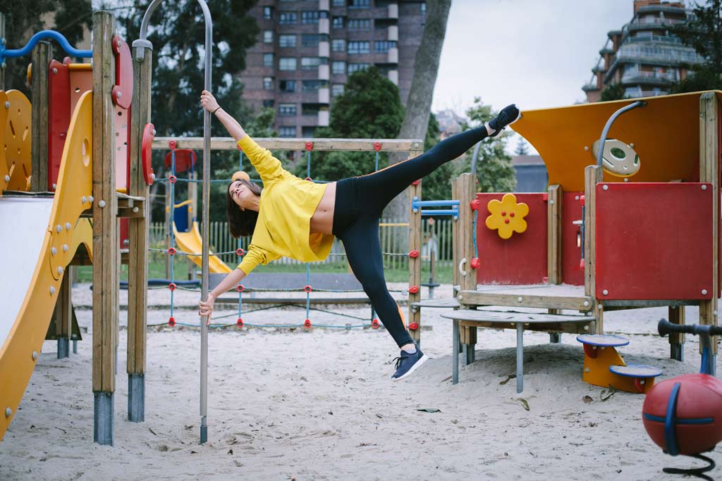 woman doing human flag in playground