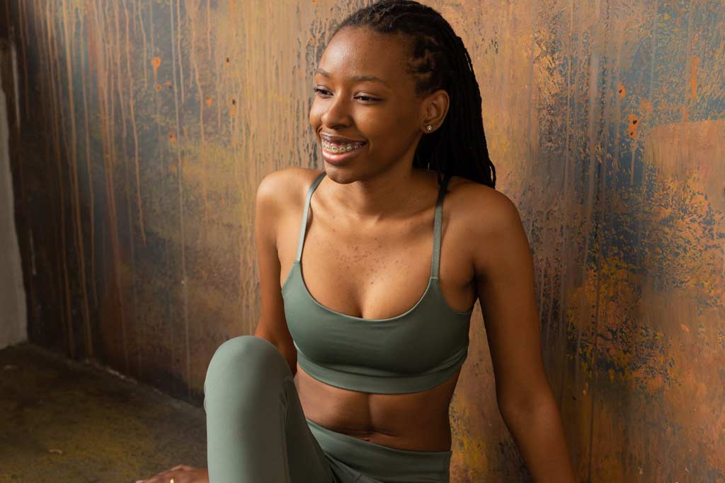 woman smiling and sitting after calisthenics supersets
