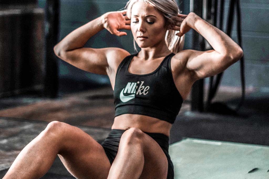 woman doing beginners crunches in gym